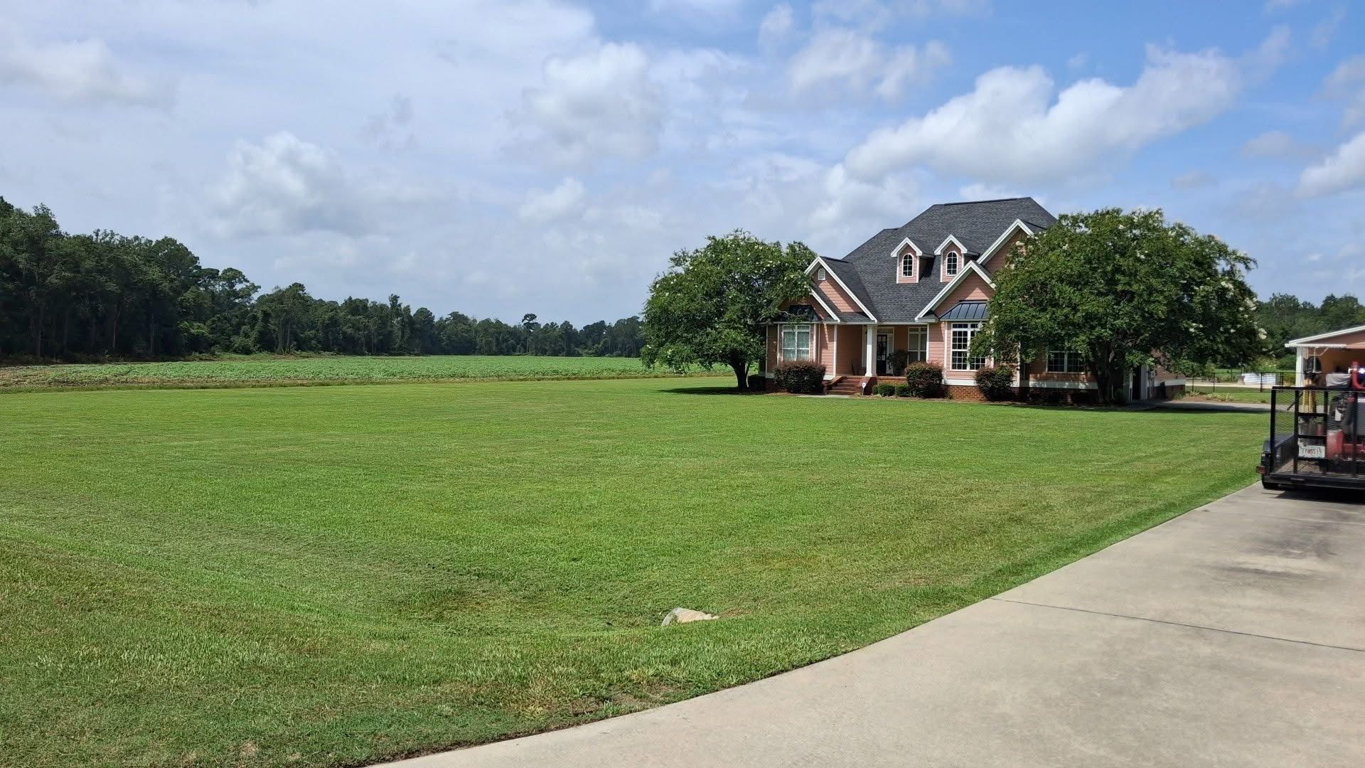 Large striped lawn in front of a two-story home